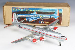 A Yonezawa tinplate battery operated Multi-Act DC-7C plane 'American Airlines' with moving