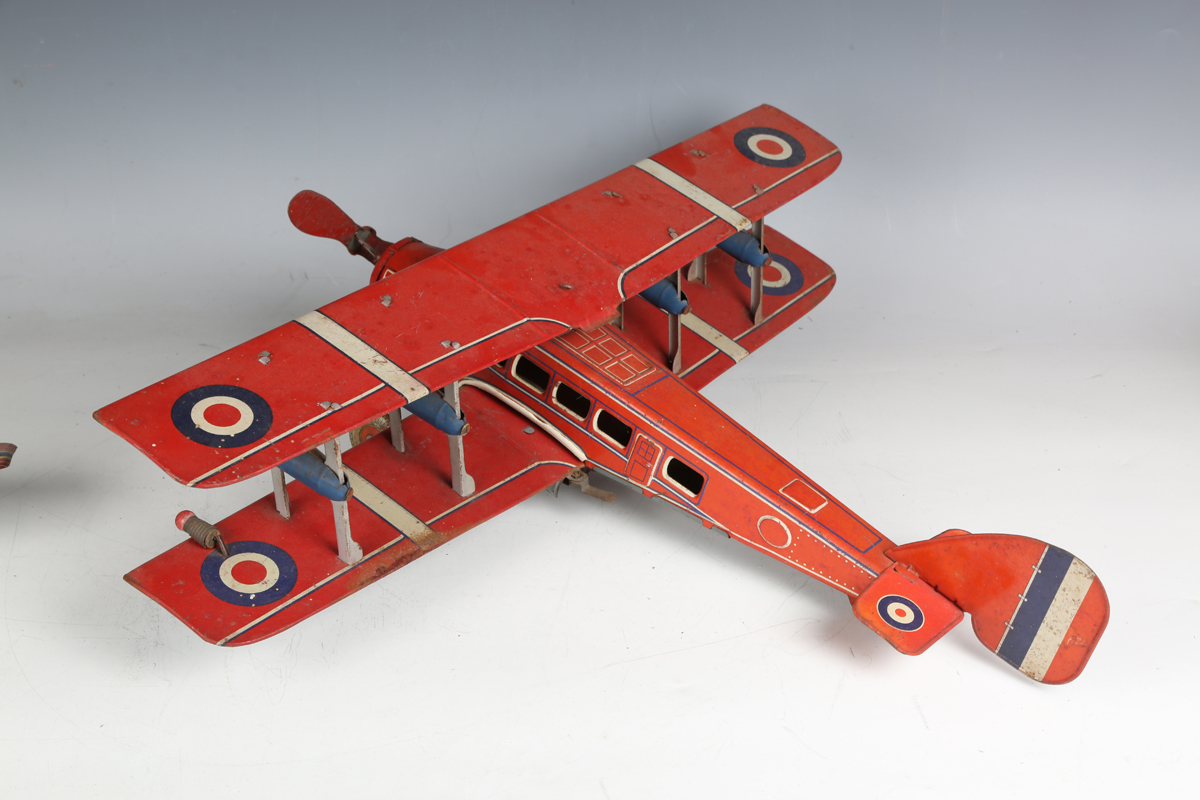 A British tinplate clockwork biplane airliner, possibly Chad Valley, finished in red with Dunlop - Image 4 of 5