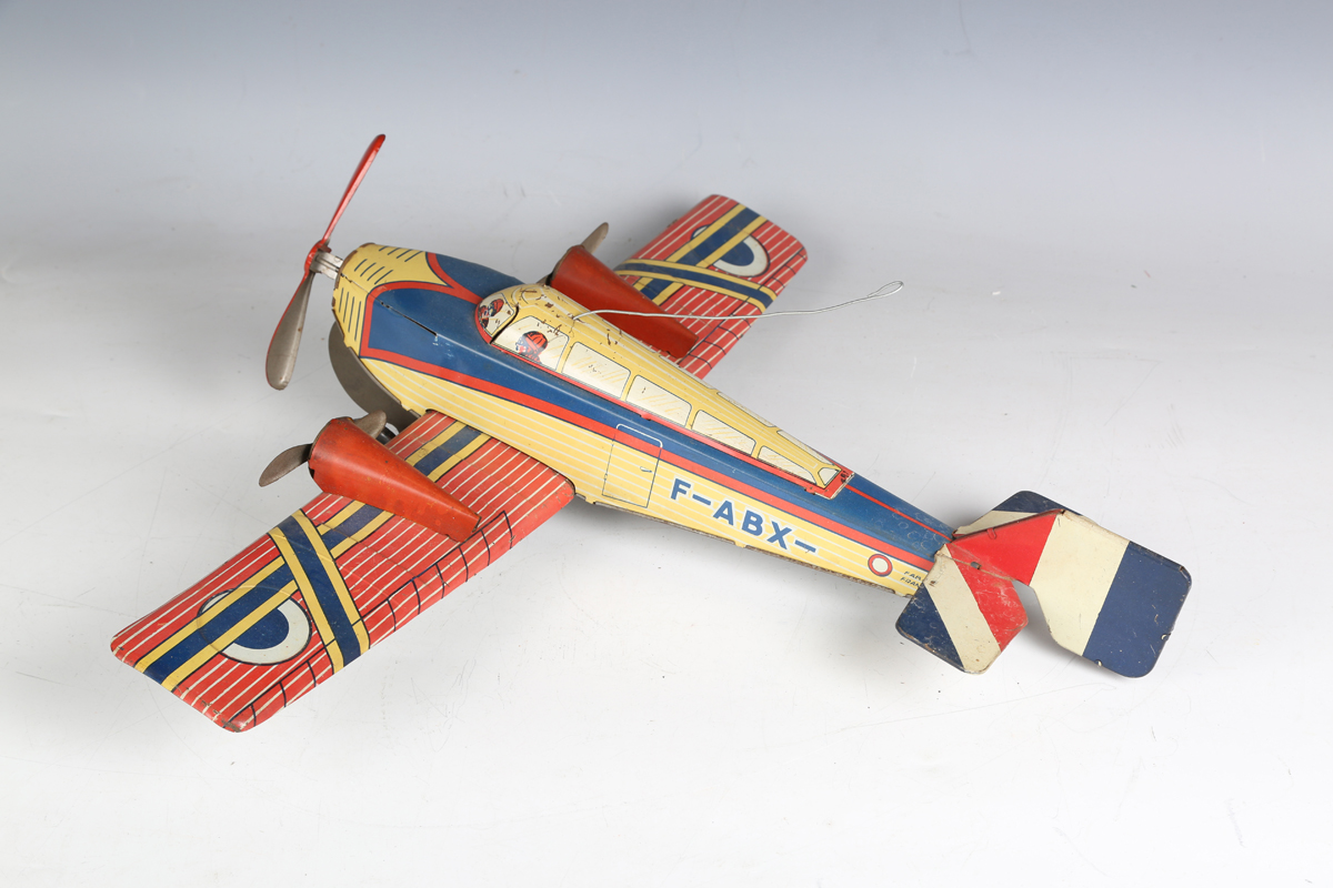 A British tinplate clockwork biplane airliner, possibly Chad Valley, finished in red with Dunlop - Image 2 of 5