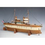 A tinplate clockwork ship with two funnels and two masts, the hull finished in brown and cream,