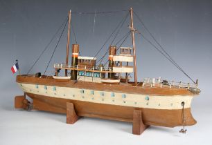 A tinplate clockwork ship with two funnels and two masts, the hull finished in brown and cream,