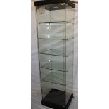 A good quality modern glass freestanding display cabinet with internal shelves,