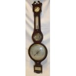 A 19th century mercury barometer with silvered circular dial below thermometer,