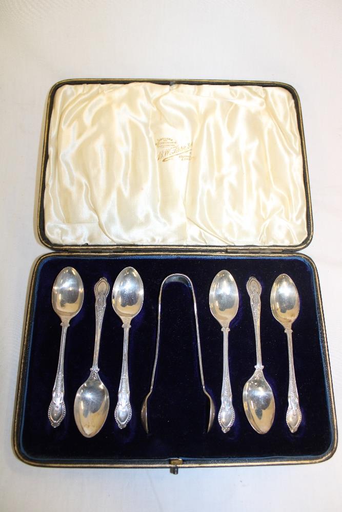 A set of six Edward VII silver teaspoons with decorated handles and matching sugar tongs,