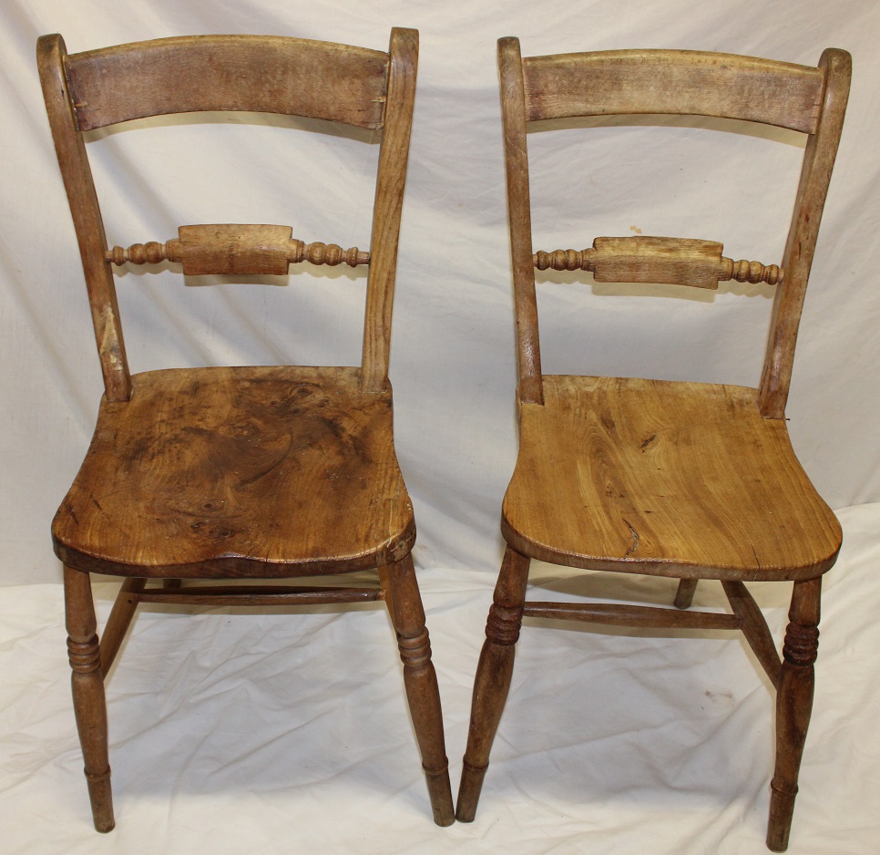 Five old matching elm and beech bar-back kitchen chairs with shaped seats on turned tapered legs