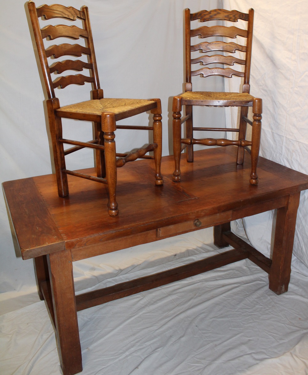 A polished oak country-style rectangular dining table with a small frieze drawer on square legs 63"