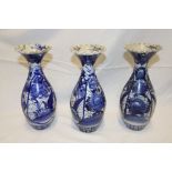 Three late 19th century Japanese pottery tapered vases with painted blue and white floral