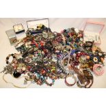 A box containing a large selection of costume jewellery including necklaces, wristwatches,