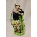 A large Victorian Staffordshire pottery figure of a highlander,