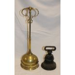 A Victorian brass door stop with scroll decorated handle 18" high and a Victorian cast iron door