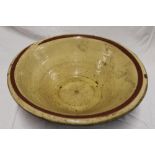 A 19th century slip glazed terracotta circular bowl