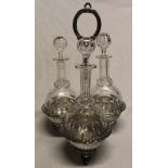 Three good quality cut-glass decanters and stoppers on silver-plated trefoil fitted stand (one