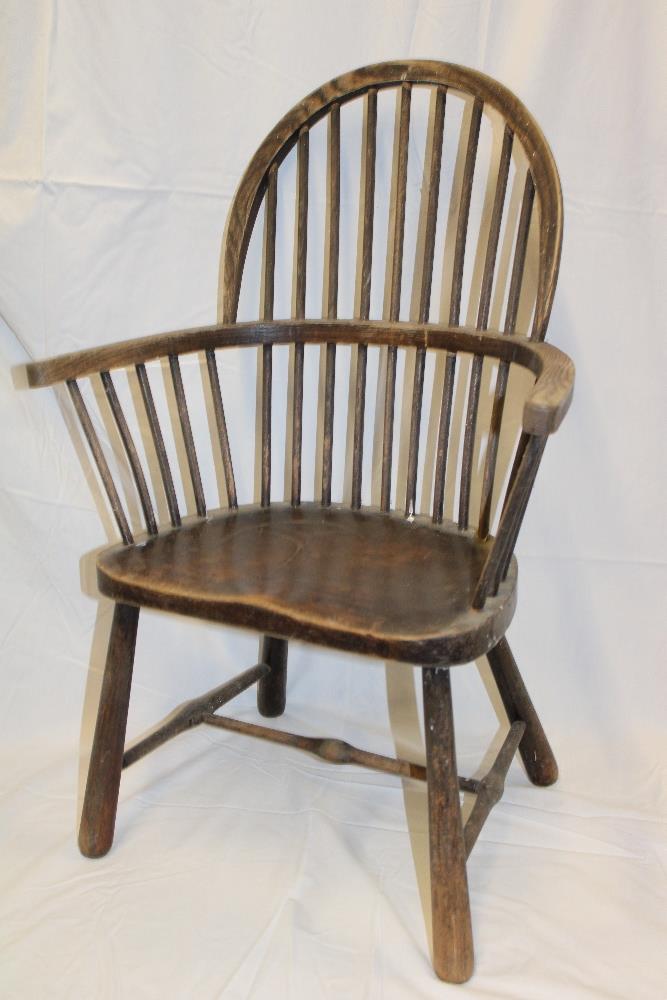 A 19th century beech child's Windsor chair with spindle back and shaped seat on tapered legs