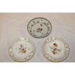 An 18th century china tea saucer with painted floral decoration and a pair of Dresden china