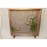 A 1930's Art Deco painted iron and wirework fire-screen depicting fish swimming amongst reeds 29" x