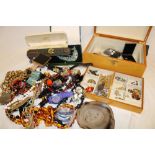 A jewellery box and basket containing a large selection of various costume jewellery including