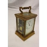 A good quality chiming carriage clock with rectangular enamelled dial in brass traditional glazed