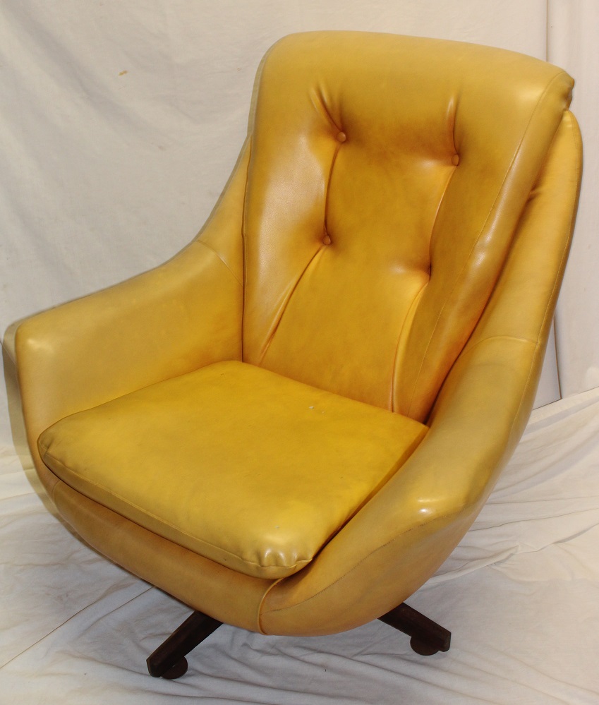 A 1960's swivel easy chair upholstered in yellow buttoned vinyl