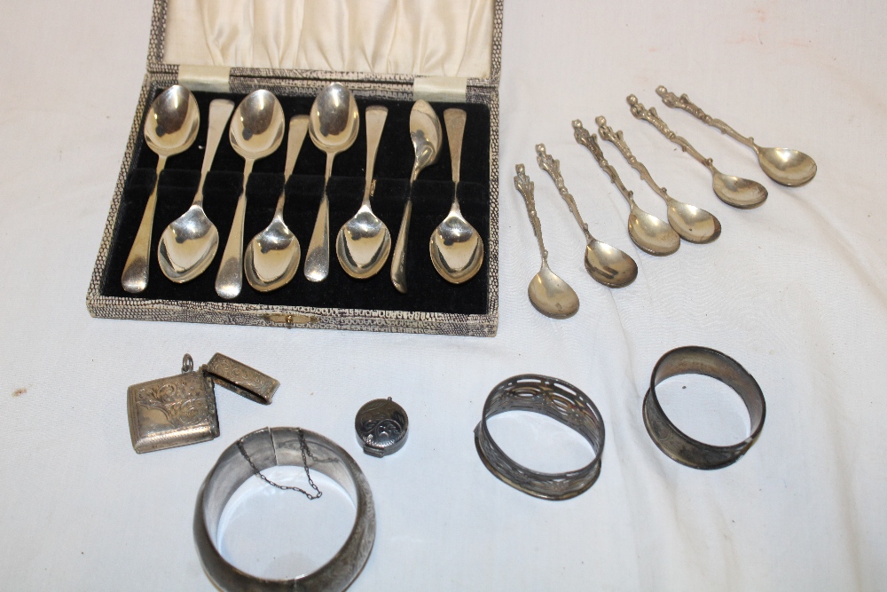 A set of six silver coffee spoons with figure decorated handles,