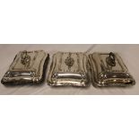 Three electroplated matching rectangular entree dishes and covers with raised scroll decoration