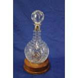 A good quality cut glass "Hoggit" tapered decanter and stopper with silver mounted neck on turned