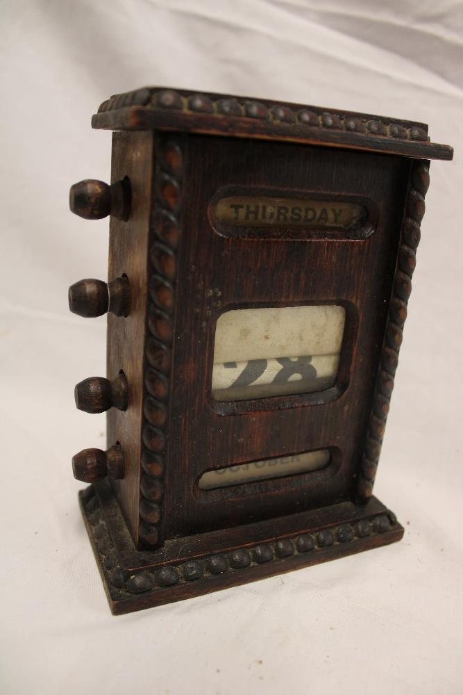 A small 1930's oak desk top perpetual calendar 6 1/2" high