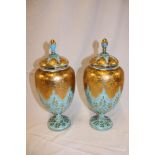 A pair of French blue tinted opaque glass pedestal vases and covers with gilt leaf decoration,