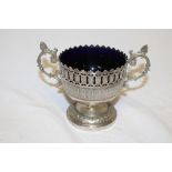 A German WMF two handled pedestal bowl with pierced decoration and blue glass liner