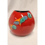 A modern Poole pottery tapered vase with multi colour decoration on red ground 10" high,