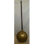 An early 19th century brass circular warming pan with iron strap handle