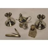 A pair of silver squat-shaped candlesticks with circular spreading bases,