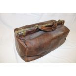 A small brass mounted leather Gladstone bag