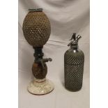 An unusual French glass and pottery liquor dispenser with canework-bound body and pewter tap 18