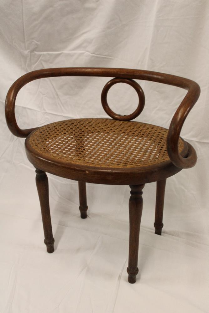 An unusual bentwood child's chair with oval canework seat on turned legs