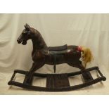 A good quality 20th century carved wood traditional rocking horse with leather saddle,