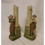 A pair of Royal Dux china spill vases in the form of classical columns with male and female