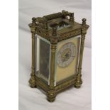 A good quality carriage clock with silvered circular dial in brass rectangular traditional case