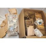A box containing numerous packets of mixed World stamps