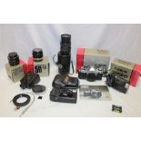 A Canon AE1 camera in original box, three additional lenses,