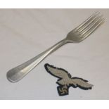 An original Second War German Luftwaffe cloth eagle and a German Luftwaffe aluminium fork (2)