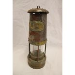 A steel and brass miner's lamp by Thomas and Williams Limited marked "GEO"