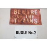 A metal rectangular railway plaque "Beware of the Trains",