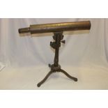 An old brass single-draw telescope,