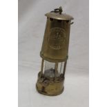 A brass miner's lamp by the Protector Lamp and Lighting Co.