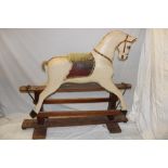 An old painted wood rocking horse on wooden rocking stand 52" long overall
