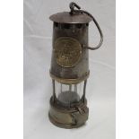 A steel and brass miner's lamp by the Protector Lamp and Lighting Co.