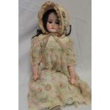 An early porcelain headed doll with leather body and porcelain lower limbs marked "1900 0" 17" long