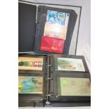 A folder album containing a collection of Hong Kong stamp presentation packs and one other album