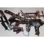 A selection of various Western-style holsters and gun belts together with modern tomahawk,