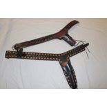 Two leather Western-style gun belts with holsters